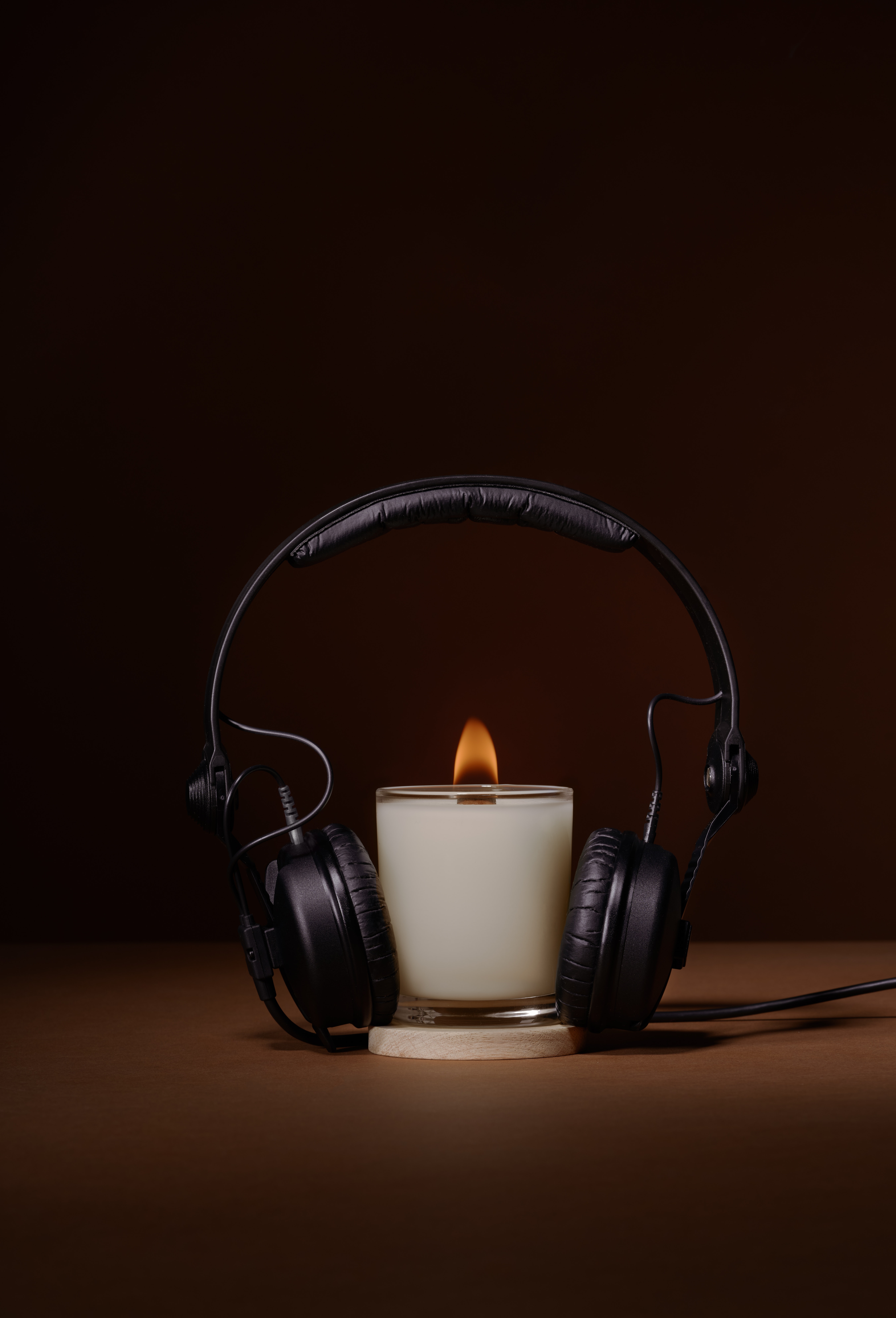 Candle under headphones